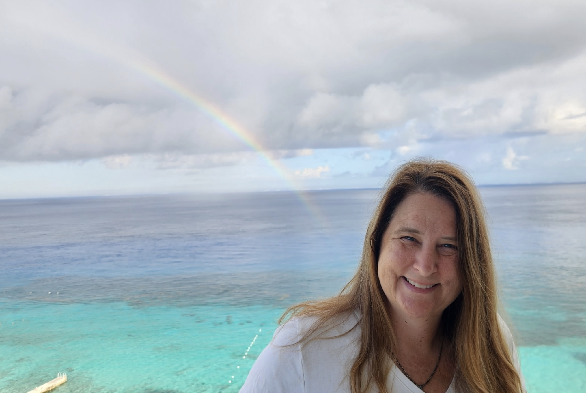 Stephanie with a rainbow in the background